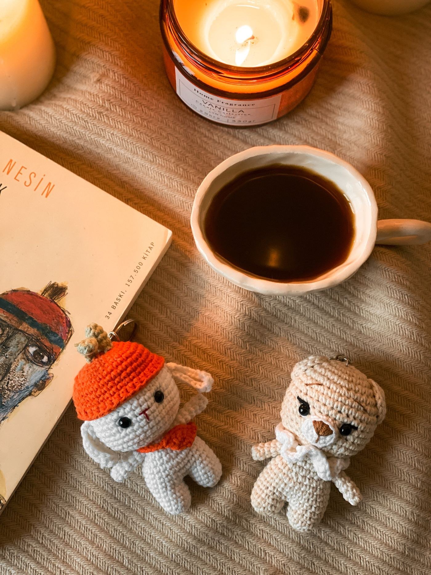 A cozy setting with coffee, candles and handmade crochet