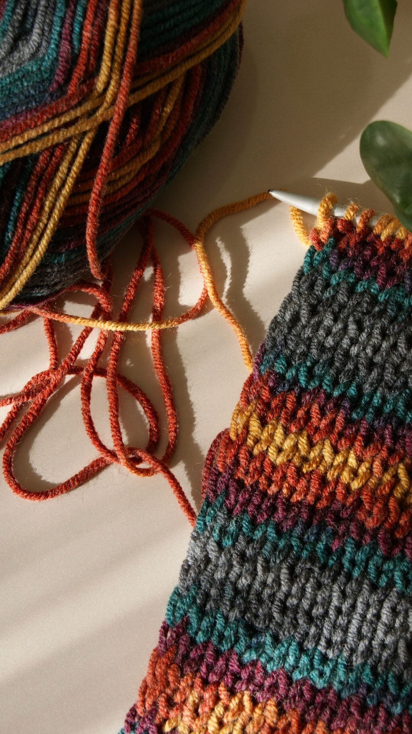 A vibrant wool project featuring colorful yarn and a knit piece